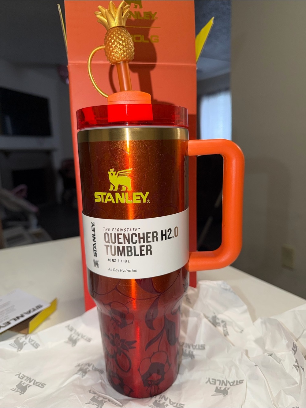 Karol G Stanley Quencher H2.0 Tumbler in metallic red with orange handle
